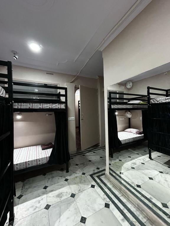 Postel nebo postele na pokoji v ubytování SREA Homestead Dormitory