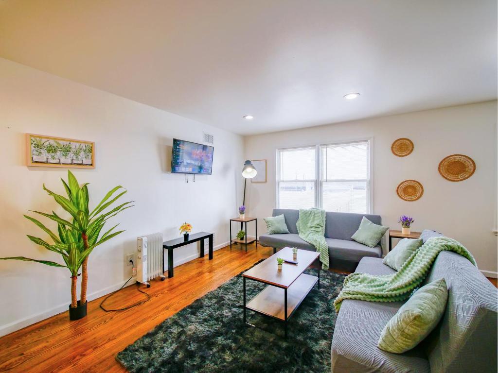 a living room with a couch and a table at Impressive 3bed 2bath apt close to NYC in Jersey City