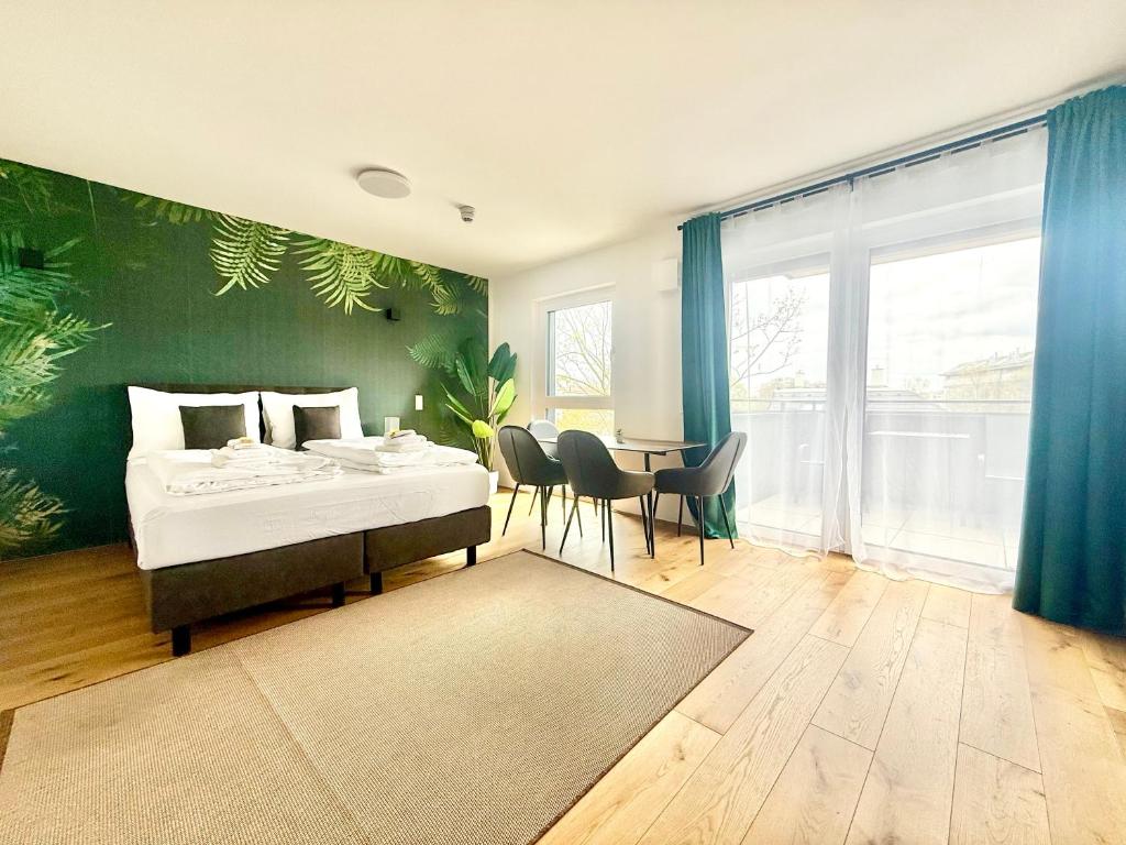 a bedroom with a bed and a table with chairs at Apartment mit Balkon und Parkplatz in Vienna
