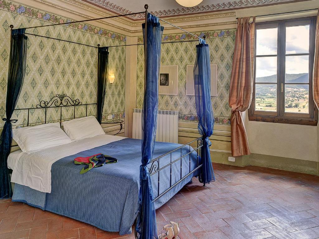 a bedroom with a bed and a canopy at Albergo San Lorenzo in Poppi