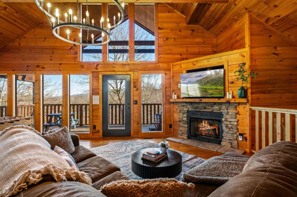 a living room with a couch and a fireplace at Blue Sage Hideaway home in Sevierville
