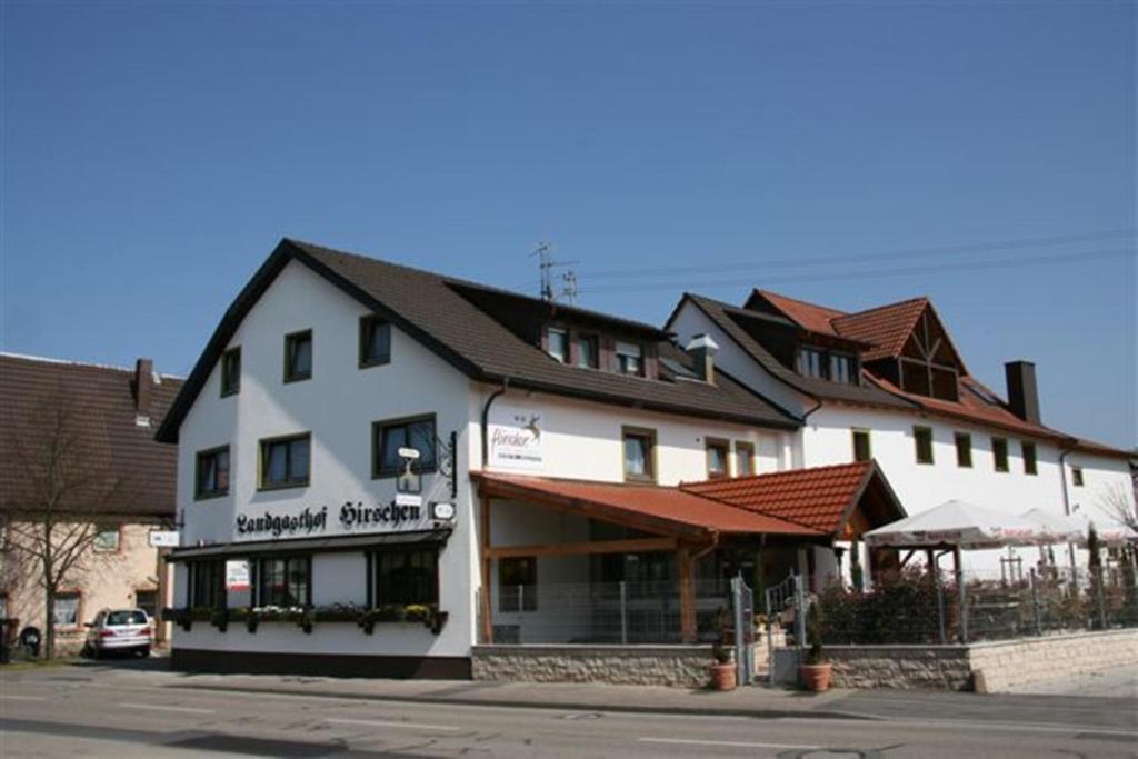 a large white building on the side of a street at Hotel-Restaurant Werneths Landgasthof Hirschen in Rheinhausen
