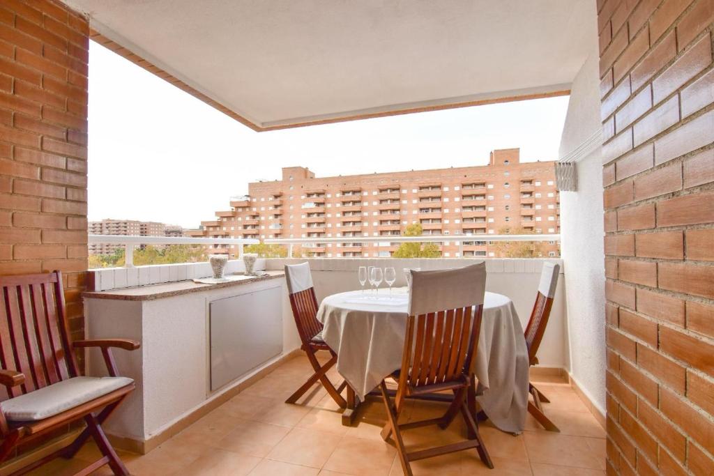 a dining room with a table and chairs on a balcony at Magic Sunset View in El Borseral
