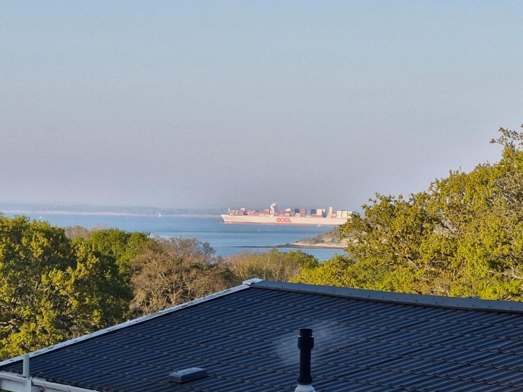 a cruise ship in the water with a house at Sea view, 73 rosewood with decking, Thorness bay in Porchfield