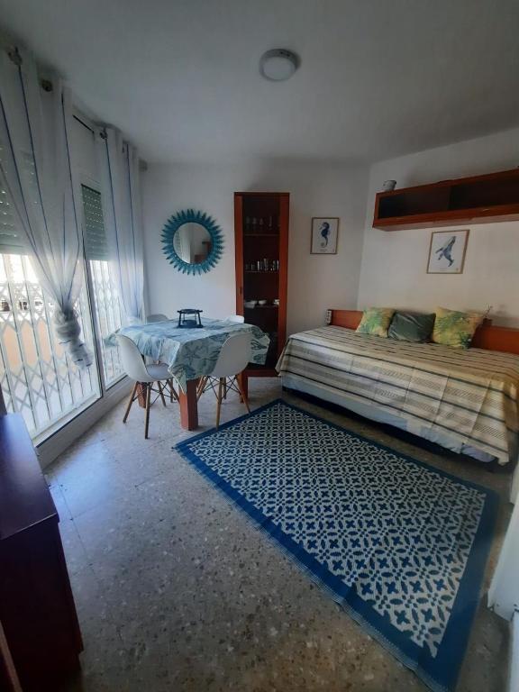 a bedroom with a bed and a table and a mirror at Eucalytus I in Salou