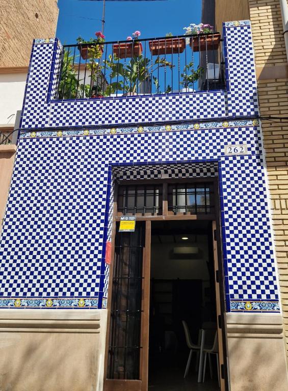 a blue and white building with a balcony at casa del Cabanyal La Playa in Valencia