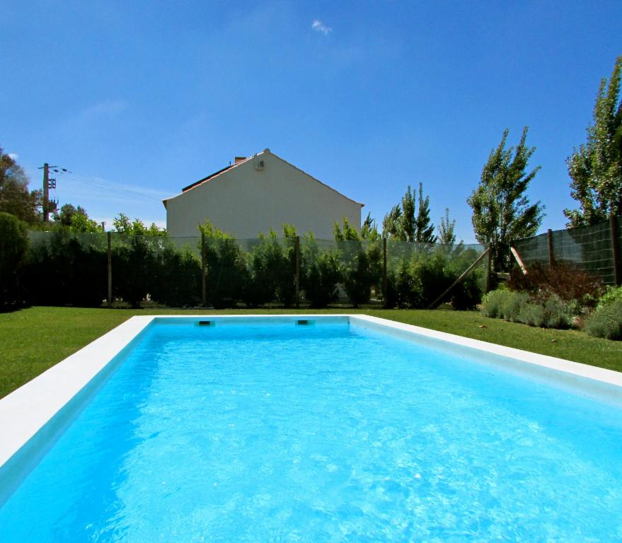 a swimming pool in a yard with a house at Amazigh-Casas de Vale Figueiras in Aljezur