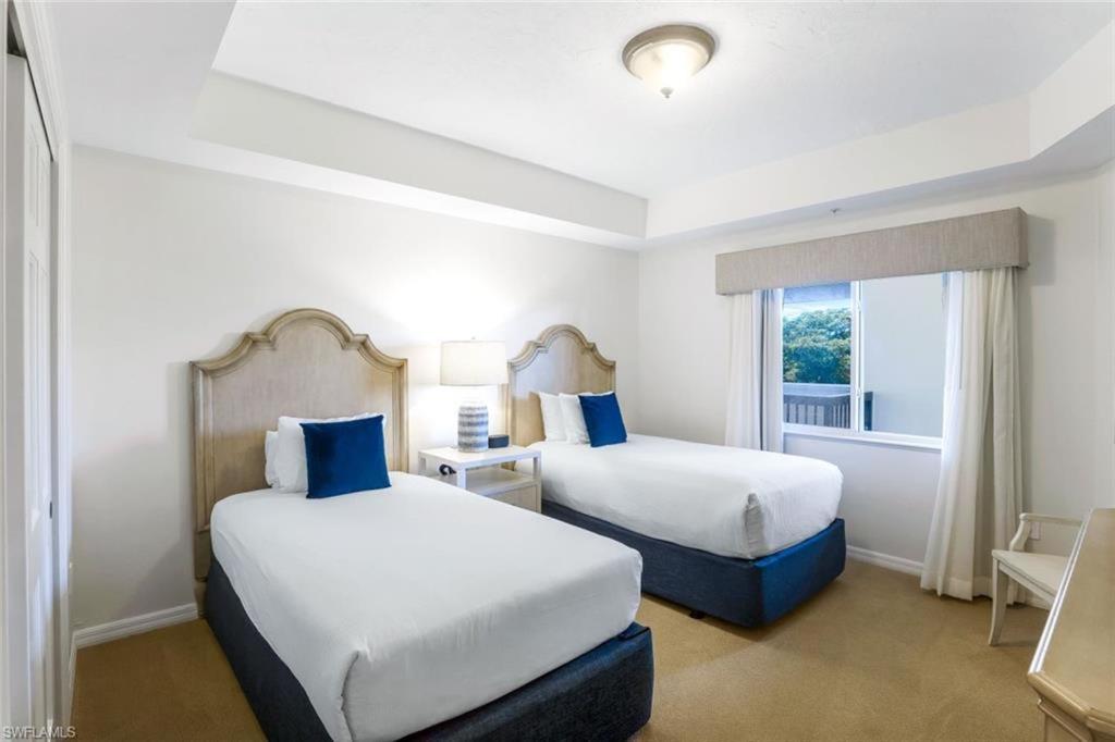 a hotel room with two beds and a window at Bellasera Resort in Naples
