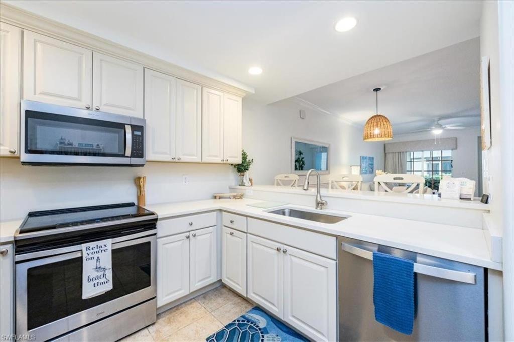 a white kitchen with a sink and a microwave at Bellasera Resort in Naples