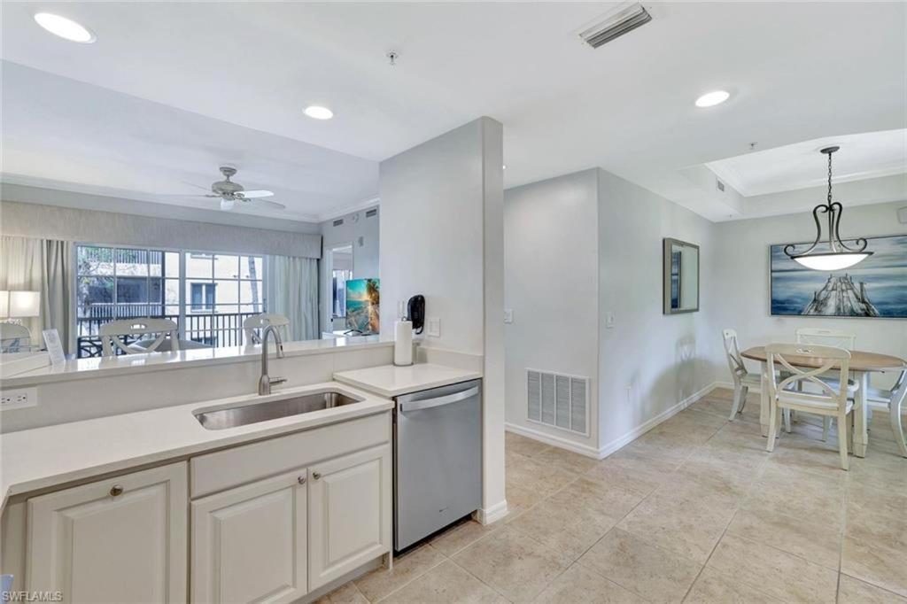a kitchen with a sink and a table at Bellasera Resort in Naples