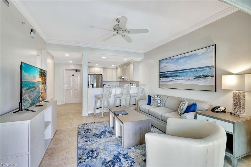 a living room with a couch and a tv at Bellasera Resort in Naples