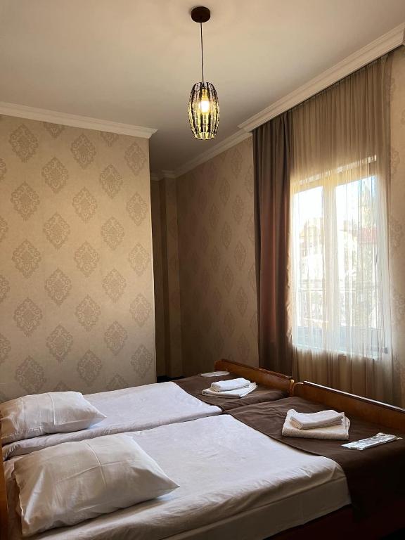 Postel nebo postele na pokoji v ubytování Arsukidze guesthouse