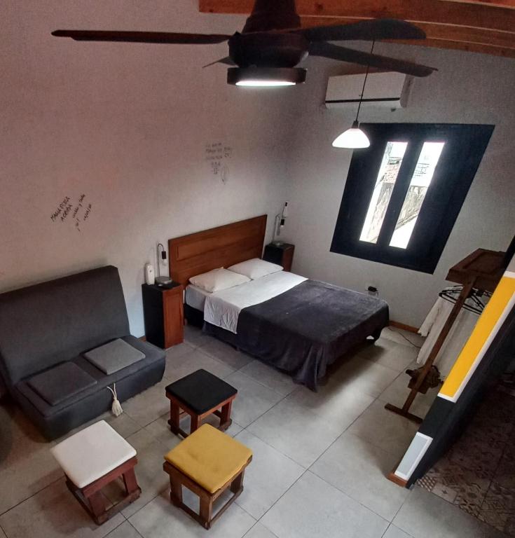 a bedroom with a bed and a couch at Úrsula, MACONDO in Cañada de Gómez