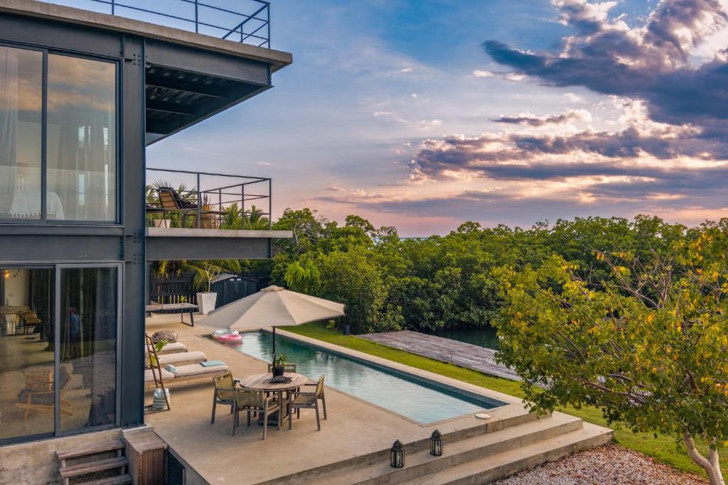an exterior view of a house with a swimming pool at Casa Balam in Placencia Village