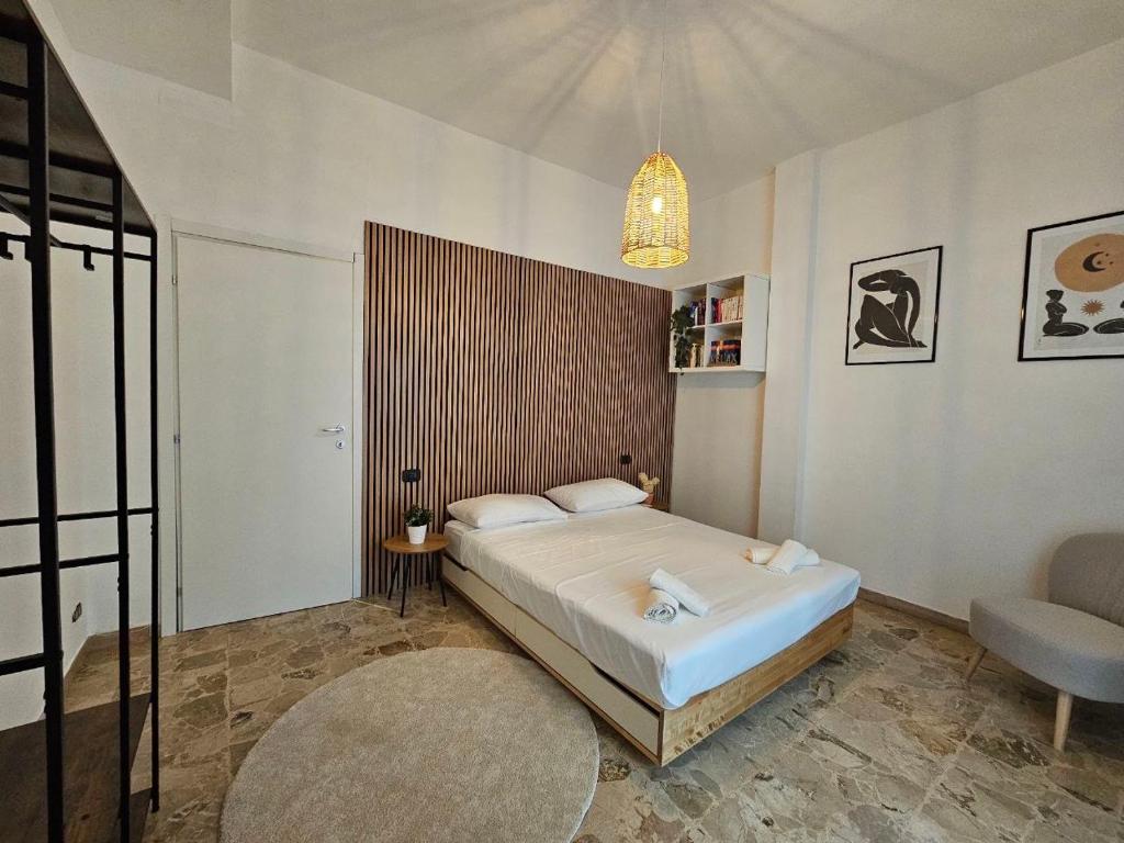 a bedroom with a bed and a chair in it at Ele's apartment in La Spezia