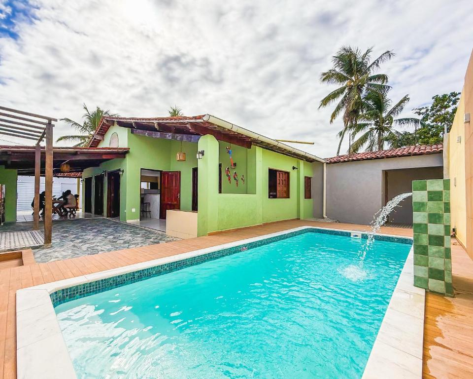 a swimming pool in front of a house at Casa com Piscina em Marechal Deodoro in Marechal Deodoro