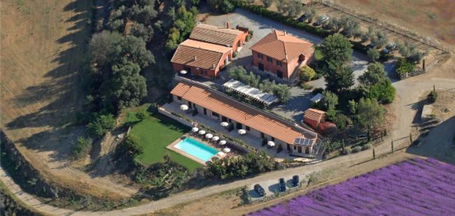 an aerial view of a large house with a swimming pool at Tenuta Saracone in Montalto di Castro
