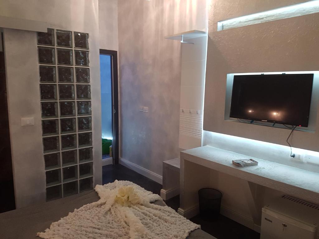 a living room with a tv on the wall at Glamour Spanish Steps in Rome