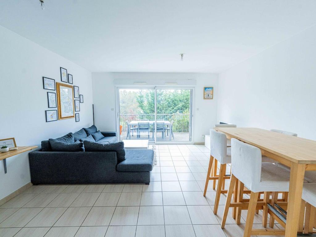 un salon avec un canapé et une table dans l'établissement Maison 2 Chambres avec Terrasse, 2 Parkings et Piscine, à Nîmes