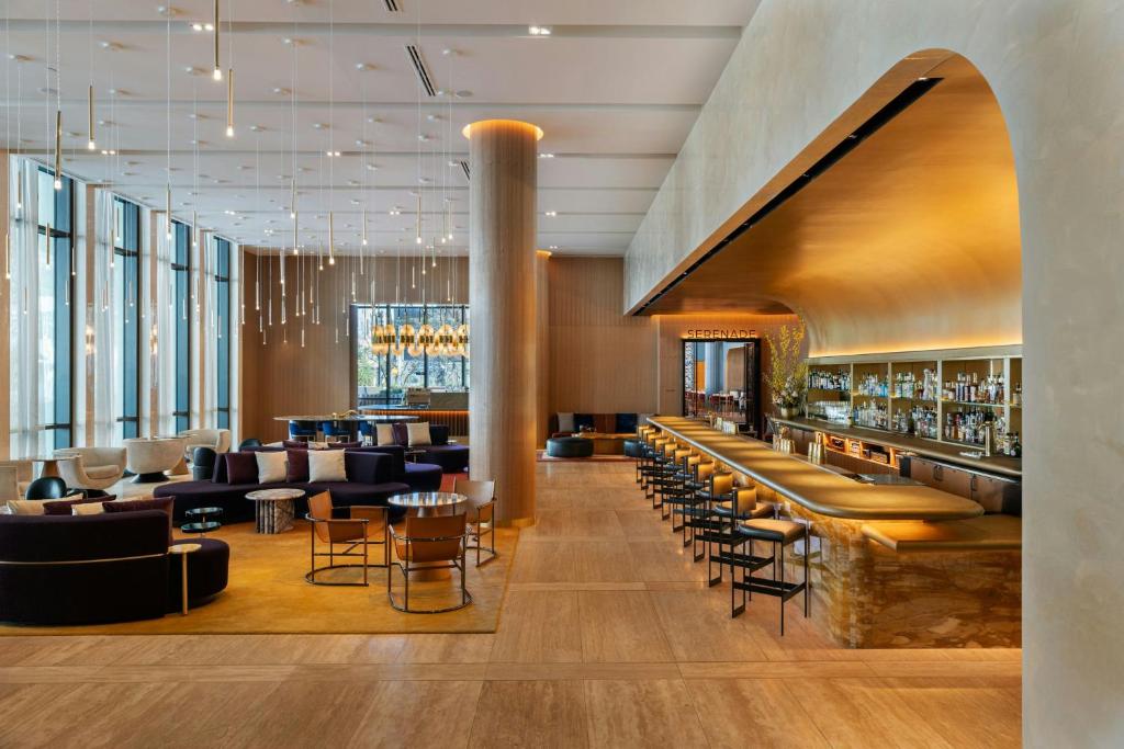 a lobby of a hotel with chairs and a bar at W Austin in Austin