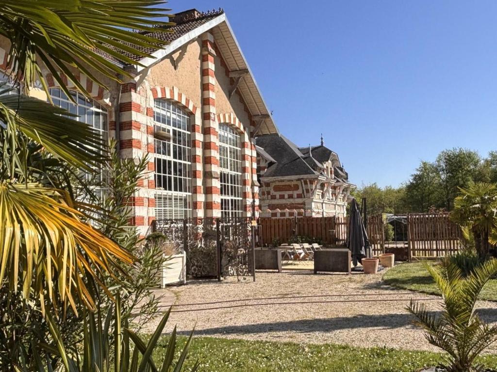 un grand bâtiment en briques avec une grande fenêtre dans l'établissement Gîte d'Art avec Climatisation et Terrasse à Savonnières - FR-1-381-614, à Savonnières