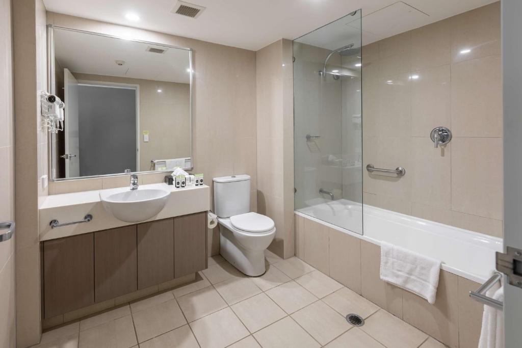 a bathroom with a sink and a toilet and a shower at Narrabeen Sands Hotel by Nightcap Plus in Narrabeen