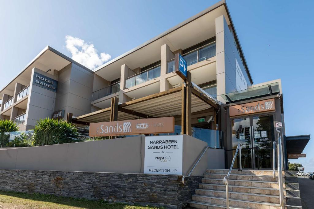 a building with a street sign in front of it at Narrabeen Sands Hotel by Nightcap Plus in Narrabeen