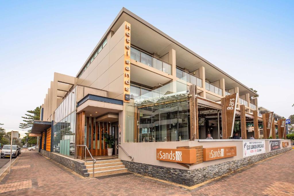 a store front of a building on a street at Narrabeen Sands Hotel by Nightcap Plus in Narrabeen