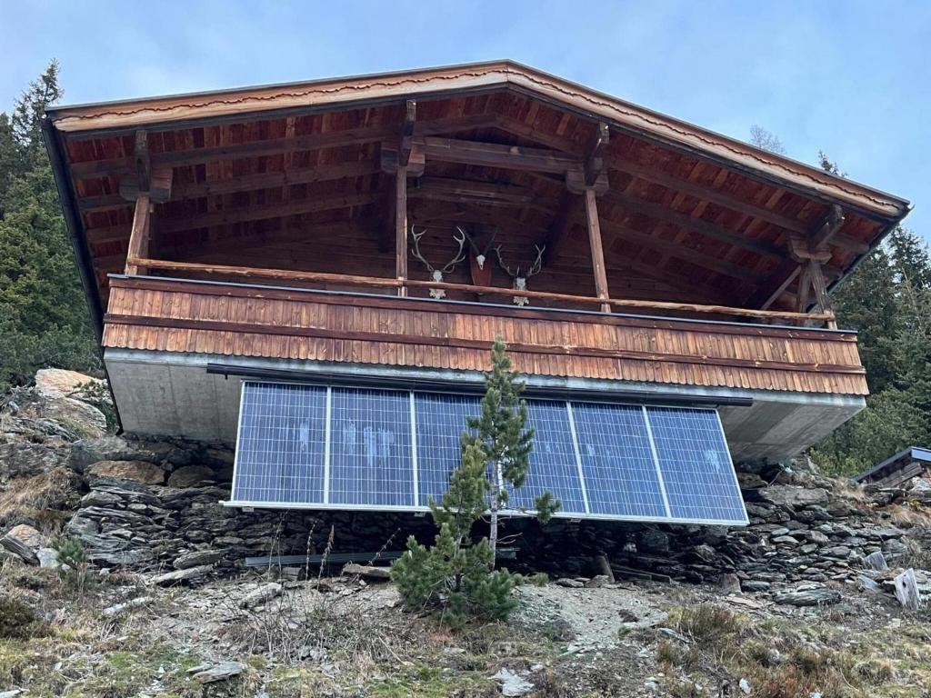 a building with solar panels on the side of it at Rustic Hut Salzburg near Ski Slopes in Bramberg am Wildkogel