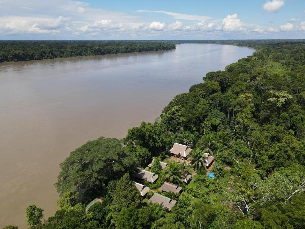 an aerial view of a river with trees and houses at Ecolucerna Lodge Tambopata in Puerto Maldonado