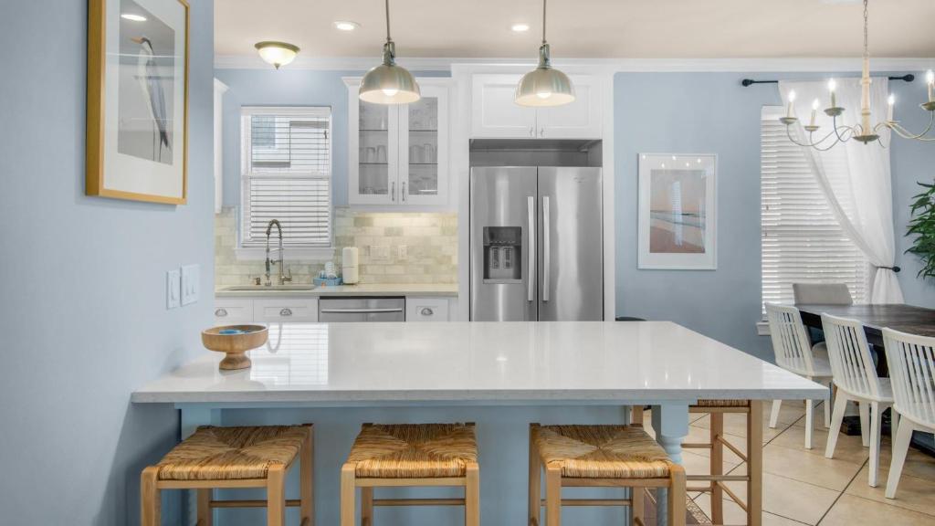 eine Küche mit einem großen weißen Tisch und Stühlen in der Unterkunft The Bluefin - Luxury Beach Home! in Destin