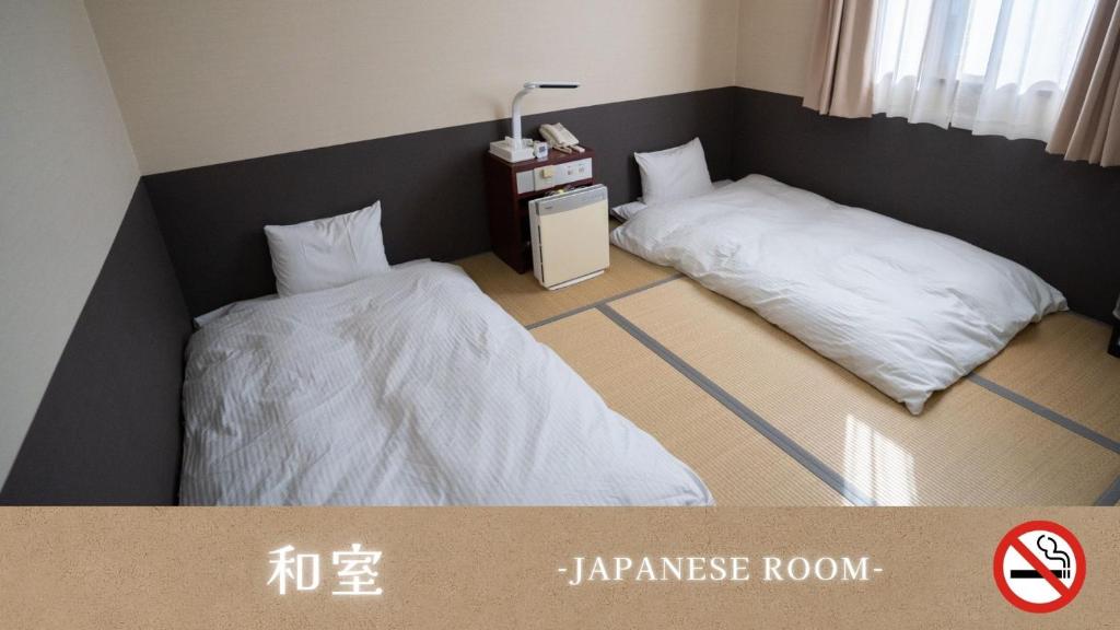 Postel nebo postele na pokoji v ubytování ホテルグリーンヒル美浜