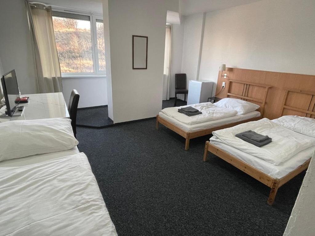 Postel nebo postele na pokoji v ubytování Hotel Joker
