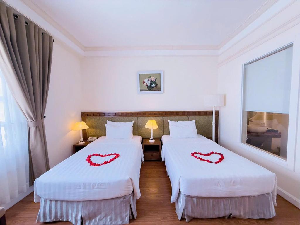 Postel nebo postele na pokoji v ubytování Phoenix Hotel Vung Tau