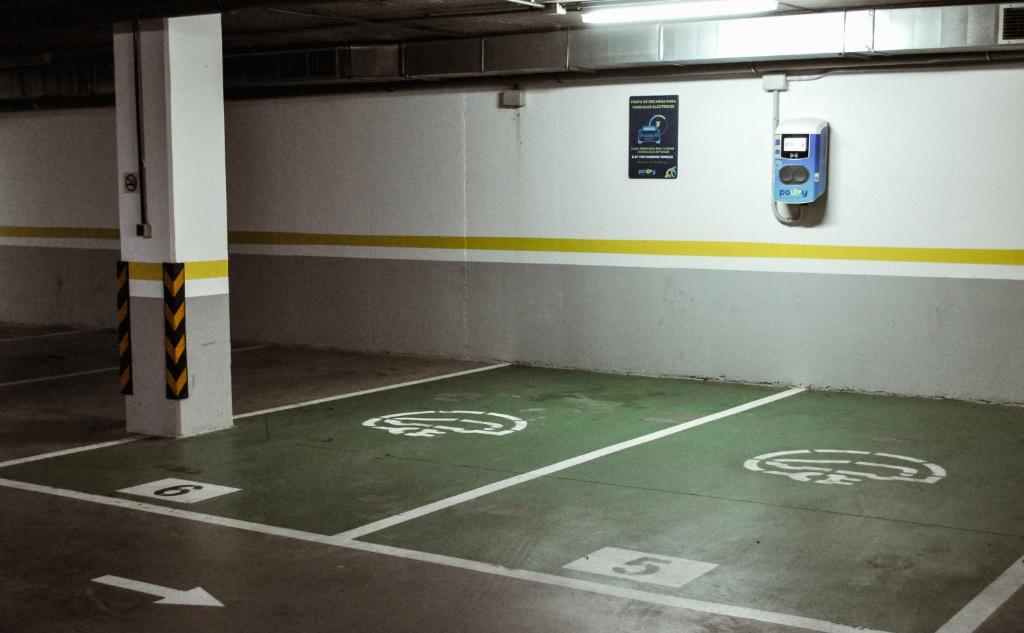 an empty parking garage with a parking meter on the floor at Abba Huesca in Huesca
