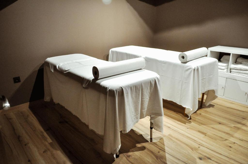 a room with two tables with white table cloth at Abba Huesca in Huesca