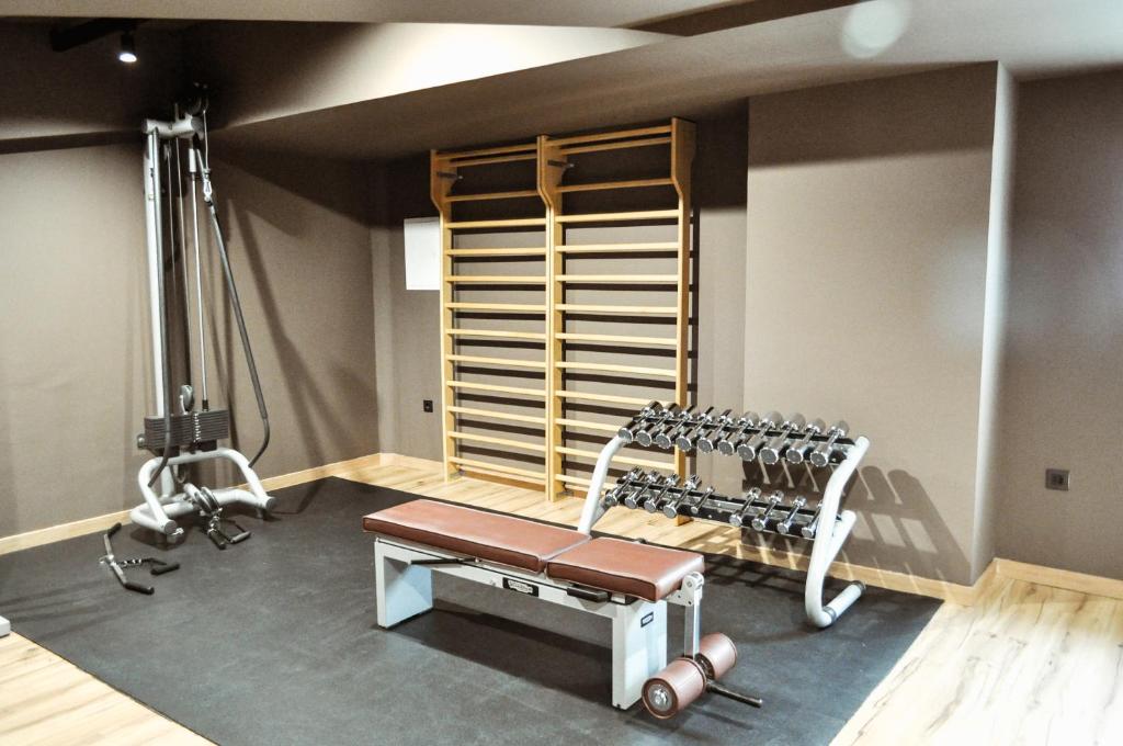 a room with a gym with a bench and weights at Abba Huesca in Huesca