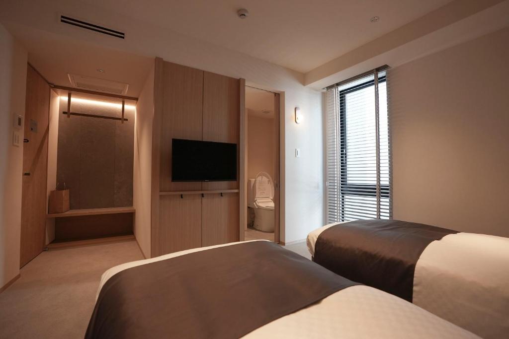 Postel nebo postele na pokoji v ubytování Hotel S-Presso South II