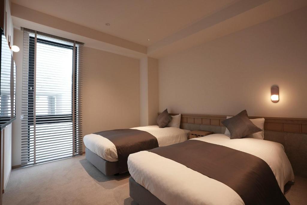 Postel nebo postele na pokoji v ubytování Hotel S-Presso South II