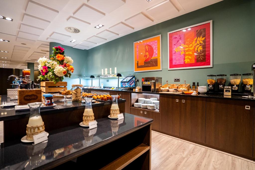 a restaurant with a buffet line with food at Abba Huesca in Huesca