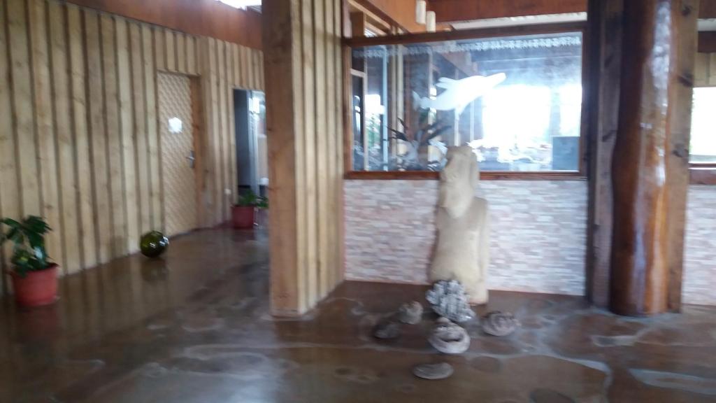 a statue of a person in a room at Tupa Hotel in Hanga Roa