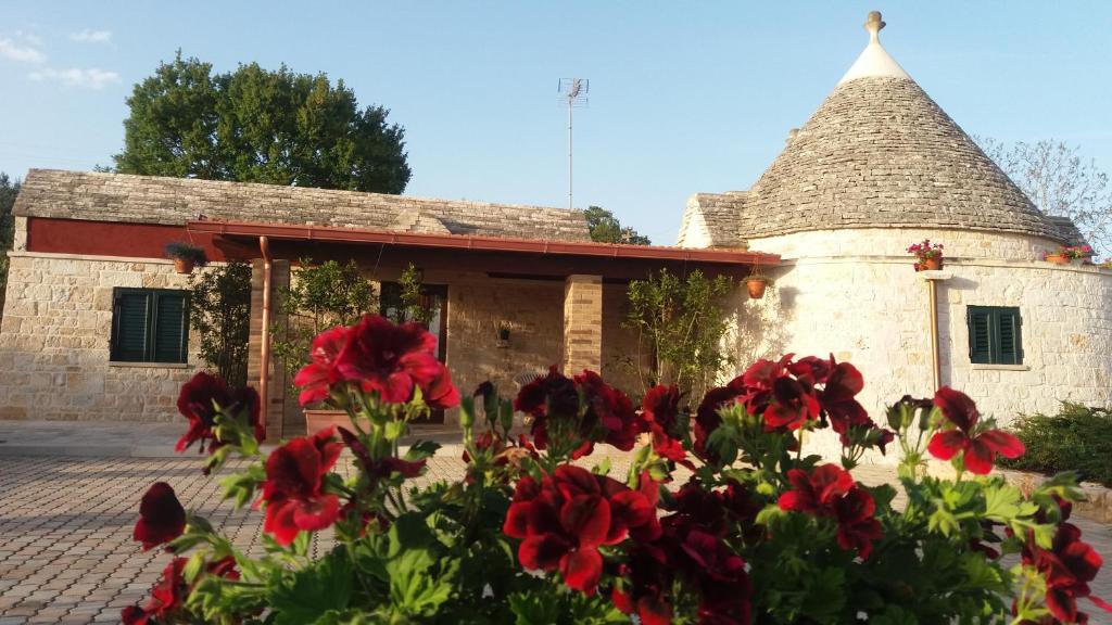 a building with red flowers in front of it at Residenza Di Nonna Giulia in Locorotondo