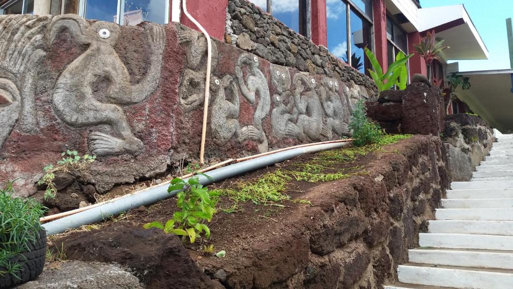 a wall with a mural of animals on it at Tupa Hotel in Hanga Roa