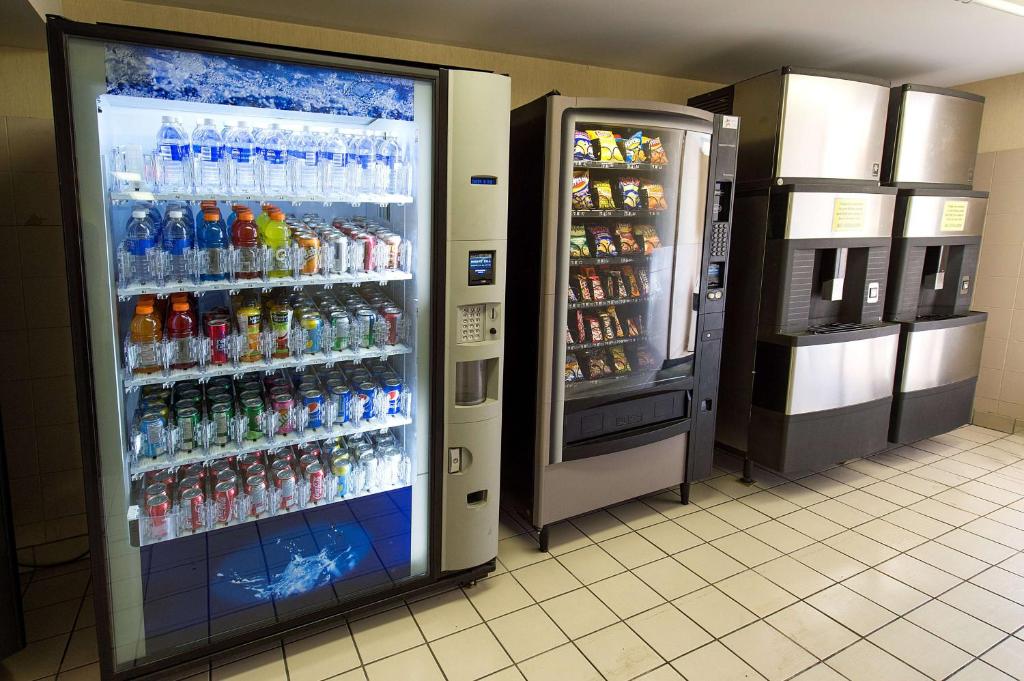 a vending machine filled with lots of bottles of soda at Howard Johnson Plaza by Wyndham by the Falls Niagara Falls in Niagara Falls