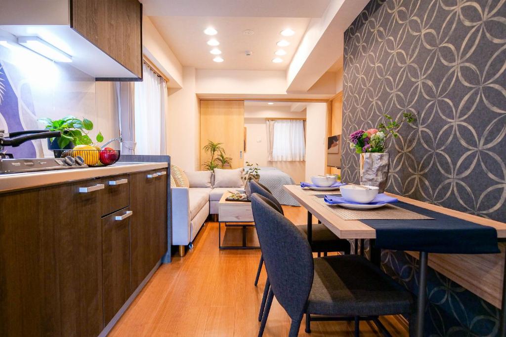a kitchen and living room with a table and chairs at Residence Hotel Ryogoku in Tokyo