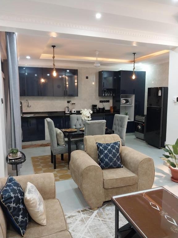 a living room with two couches and a kitchen at The Residence Beach Apt Nyali in Mombasa