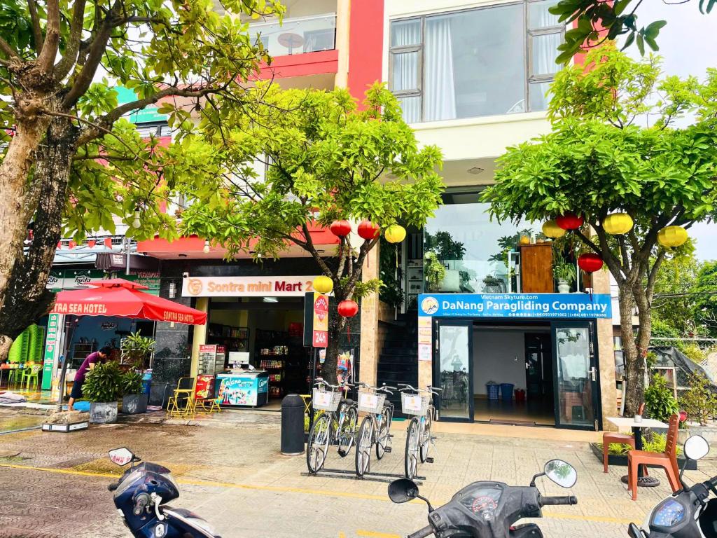 a group of scooters parked in front of a building at Sontra Sea Hotel in Danang