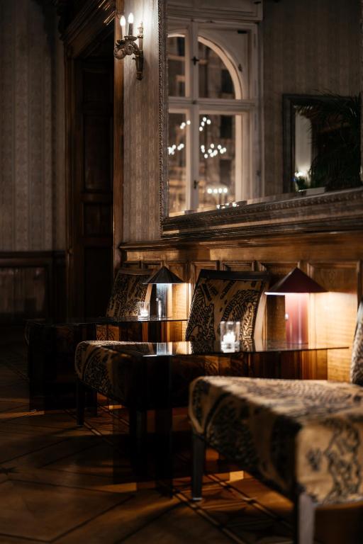 a room with chairs and a table and a mirror at The Benjamin House in Rīga