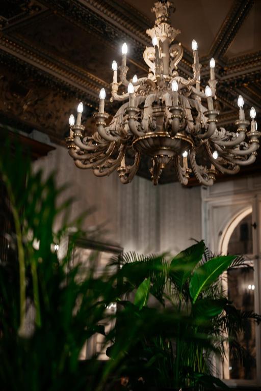 a chandelier hanging from a ceiling in a building at The Benjamin House in Rīga