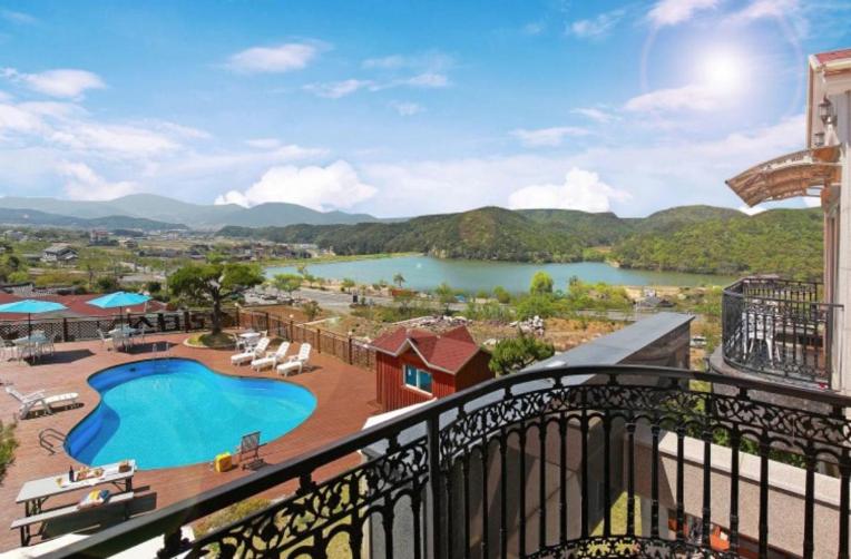 a view of a lake from a balcony of a resort at Saturday Pension Gyeongju in Gyeongju